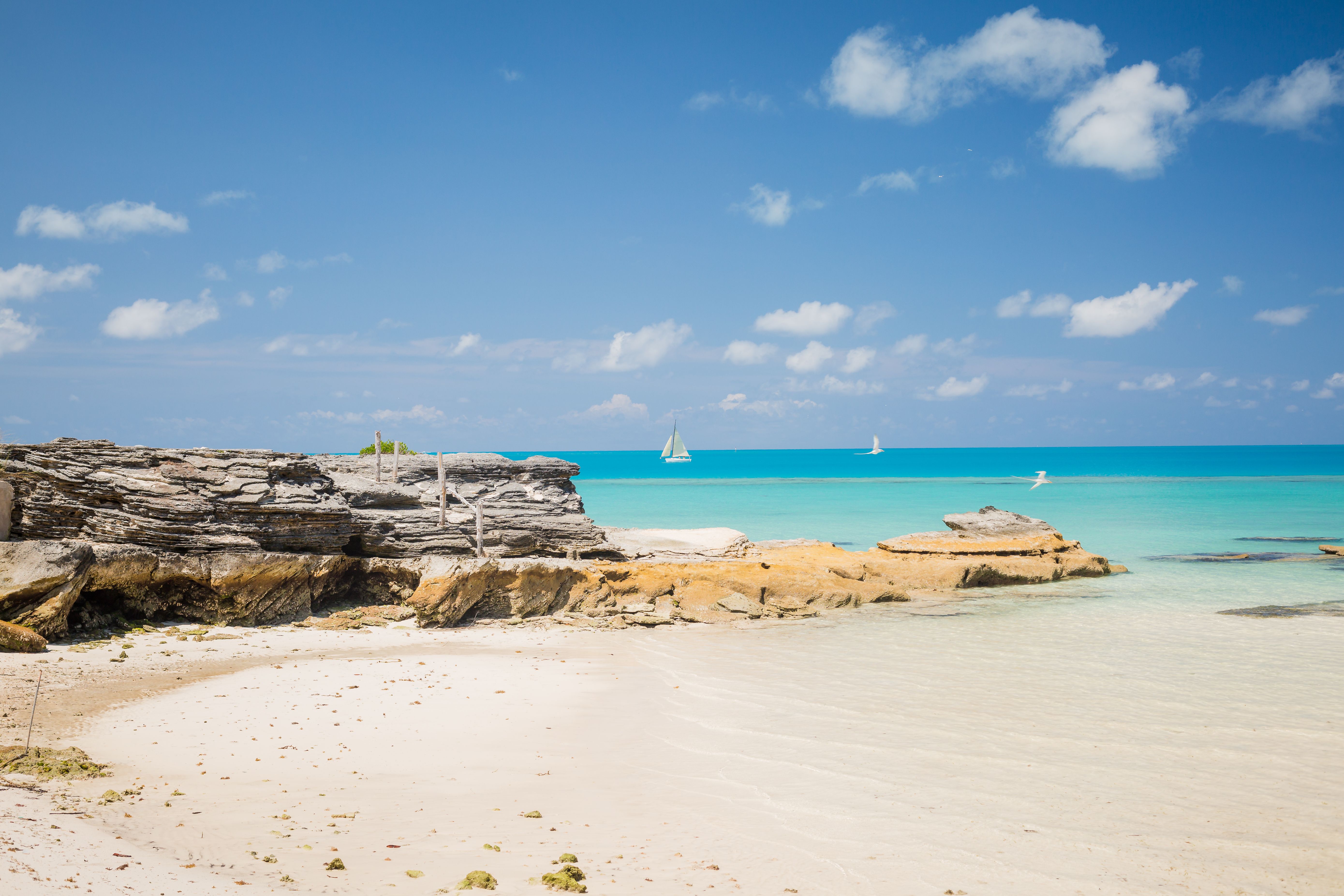 Historic pastel-colored settlement and calm turquoise waters of the Abacos